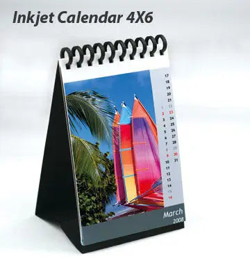 A DIY Inkjet Calendar kit featuring 13 glossy photo sheets, a black cardboard centerpiece, and two binders for easy assembly.